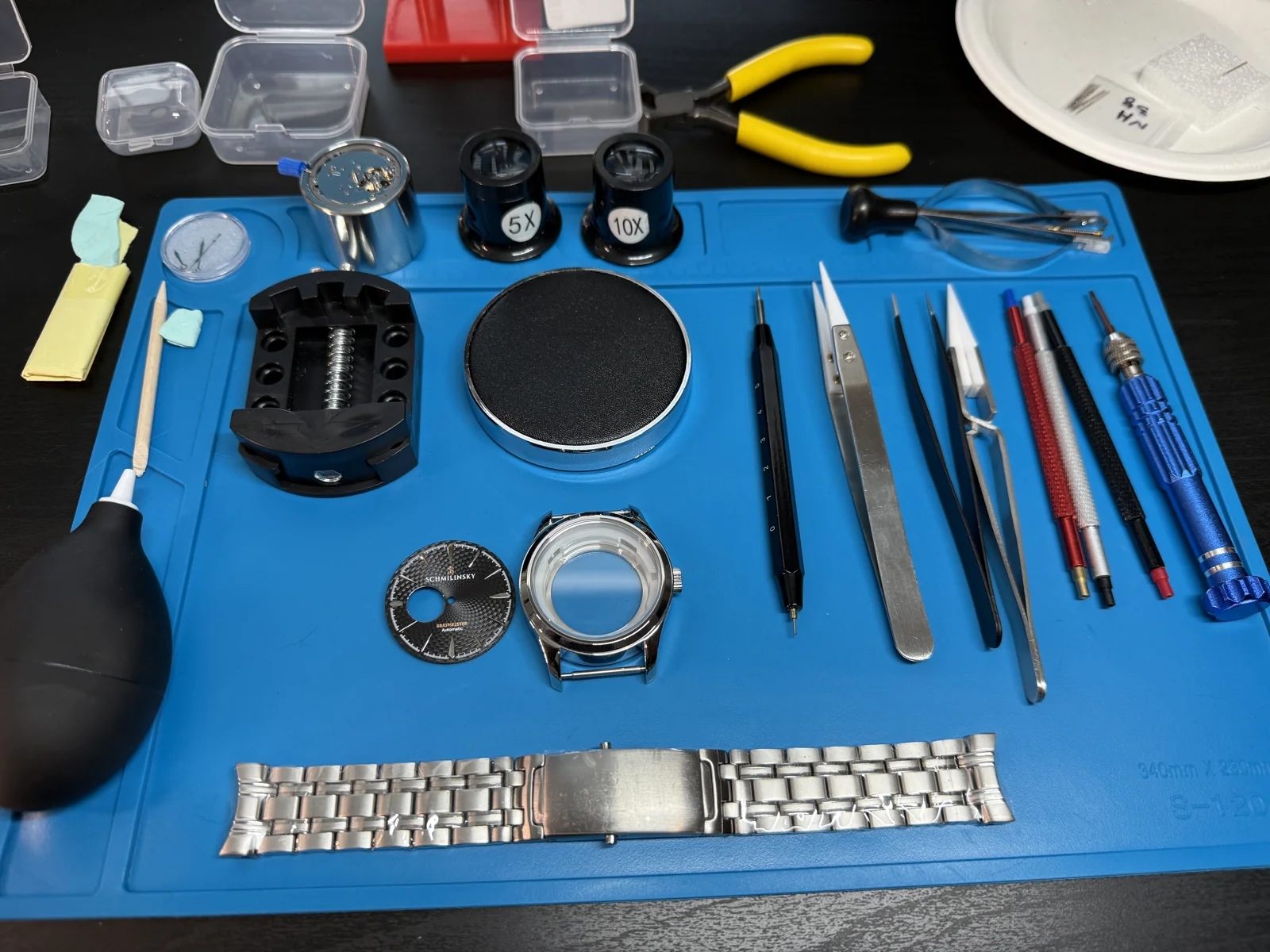 A watch disassembled on the workbench